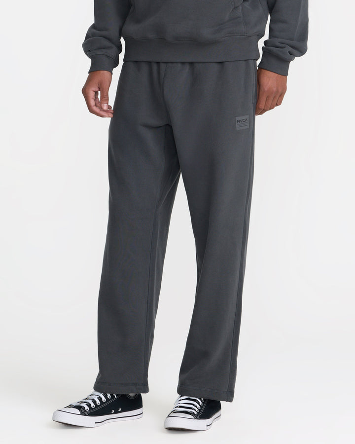 RVCA Men’s Essential Fleece Pant in Pirate Black, side view on model