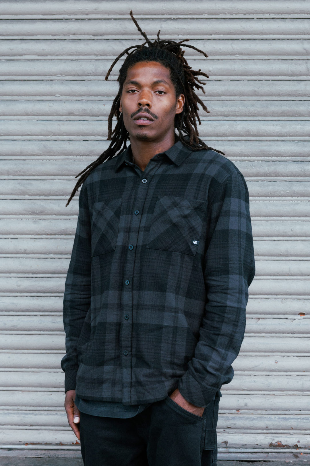 686 Men’s SMARTY Headwall Flannel in Black Plaid - front view on model
