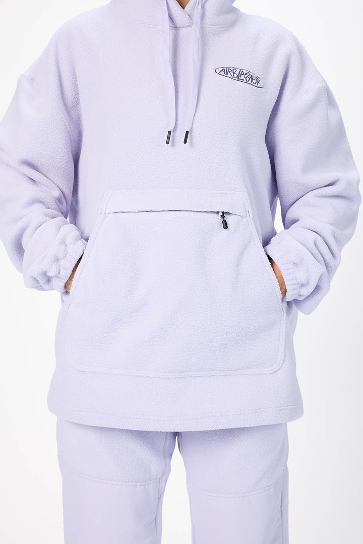 A person wearing a light lavender pullover hoodie with a kangaroo pocket and matching sweatpants against a plain white background.