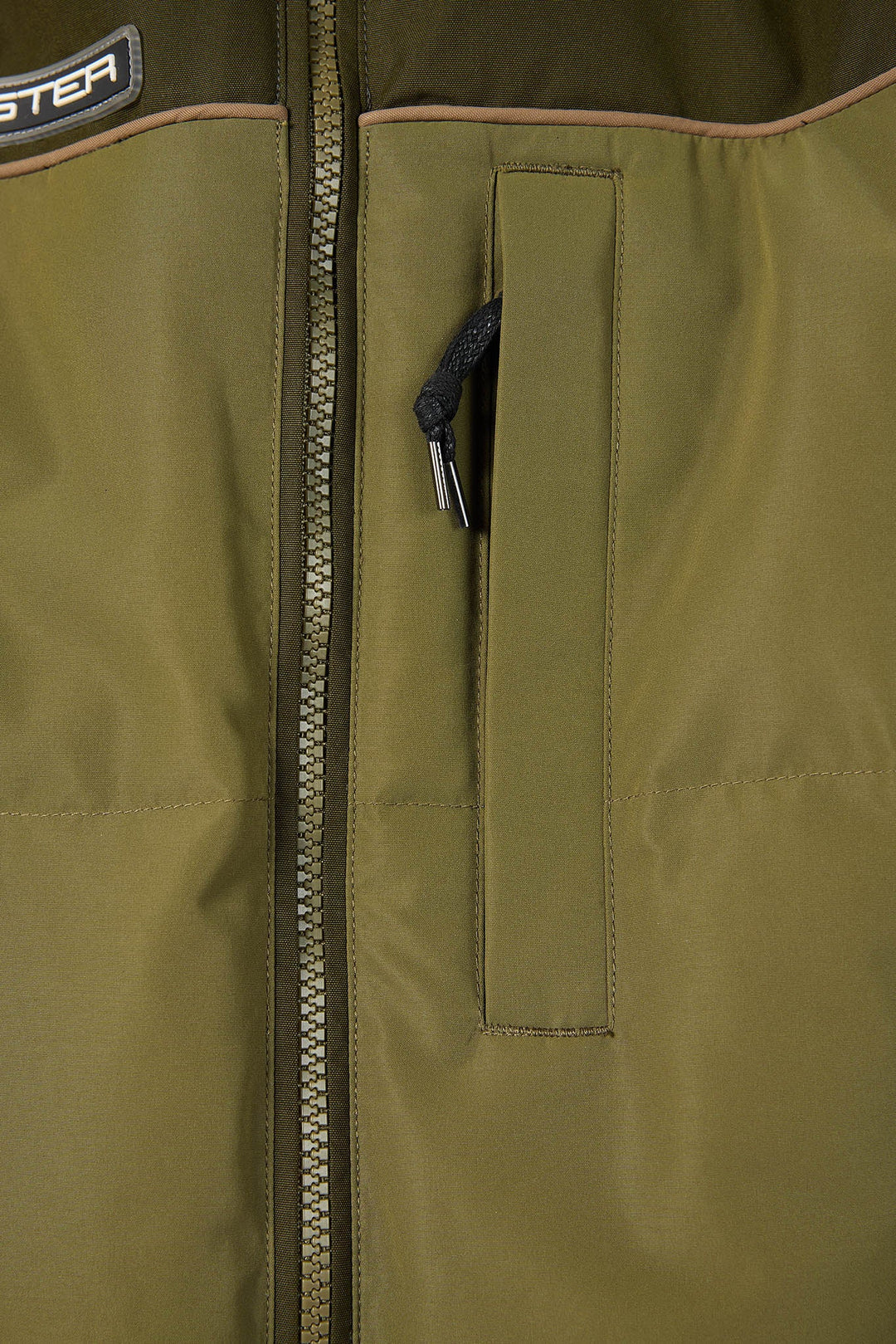 Close-up of a green jacket with a zipper and brand logo.