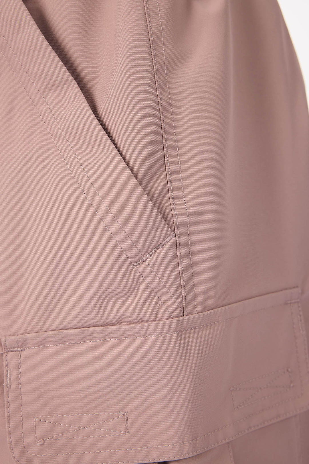 Close-up of a beige jacket with a pocket on a white background