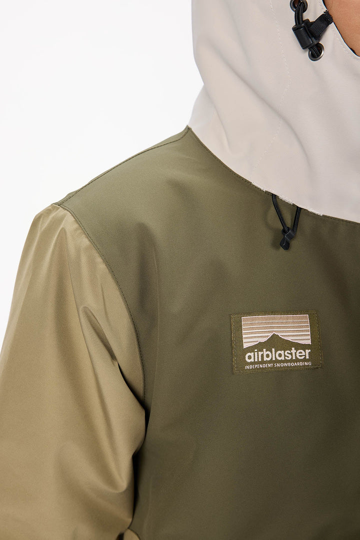 Person wearing a green jacket with an &