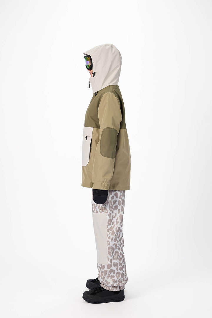 Person wearing a green and beige jacket with a white hood, standing against a white background.