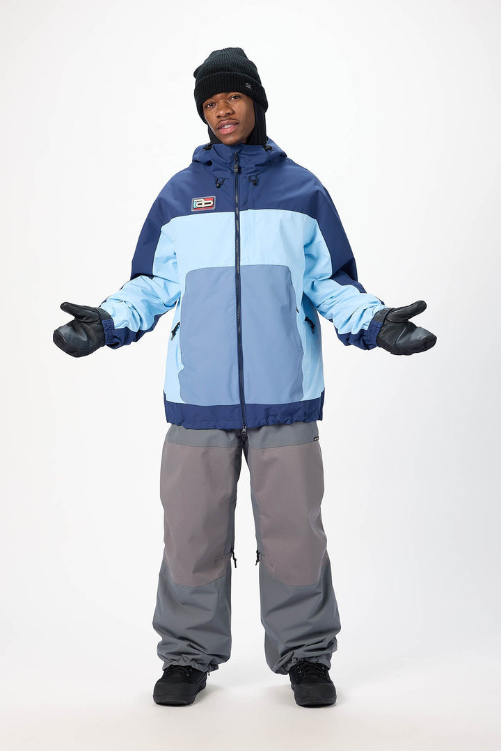 Person wearing a blue and gray snowsuit on a white background