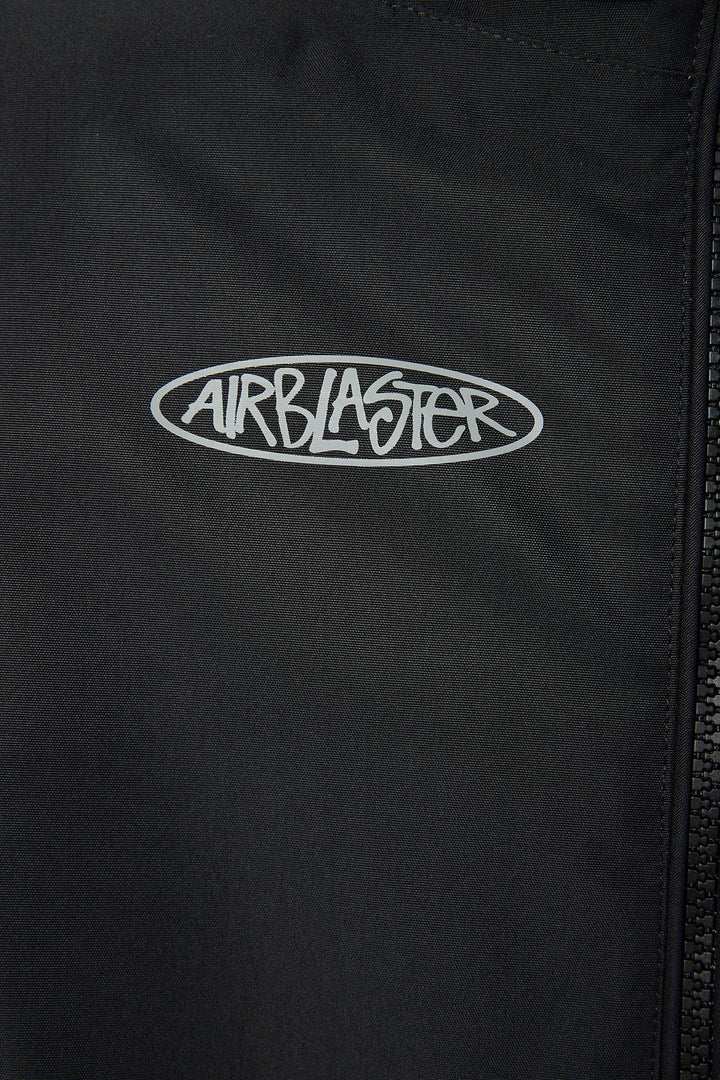 Close-up of a black zippered jacket or windbreaker with a white embroidered oval Airblaster logo on the chest.