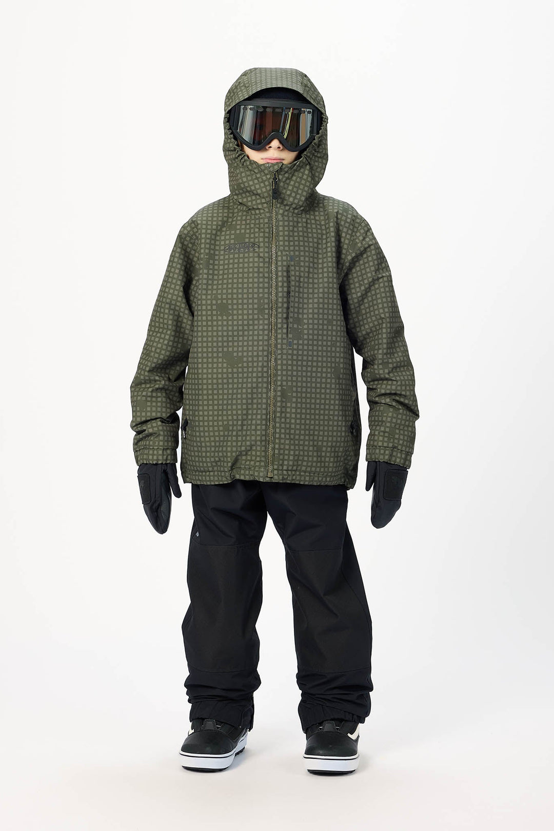A child modeling an olive green hooded snowboard jacket with a subtle grid pattern, black snow pants, black gloves, and goggles, standing against a plain white studio background.