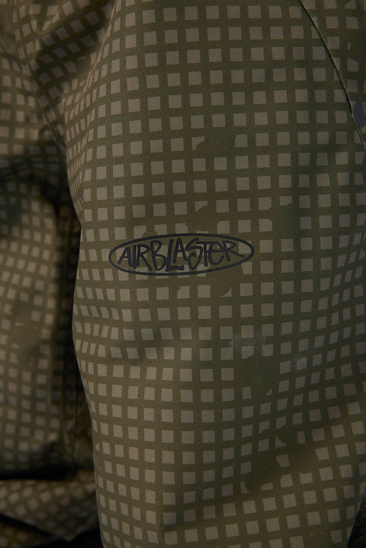 Close-up of a patterned garment featuring a gray and olive green checkered design with a dark gray Airblaster logo embroidered on the chest.