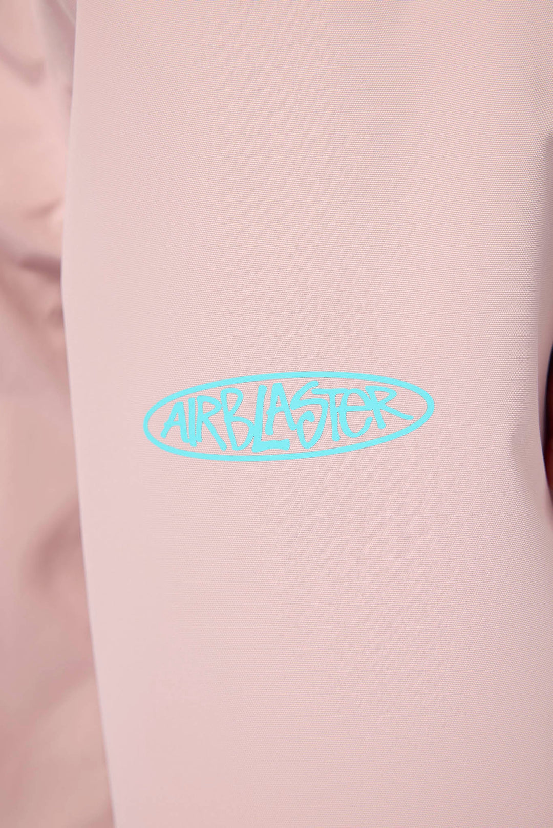 A close-up of a light pink garment featuring a light blue &