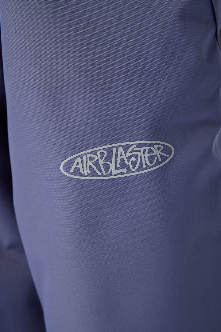 Close-up of a dusty blue or periwinkle jacket with a white outlined &